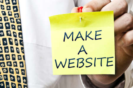 Make a website post it in business man handの写真素材