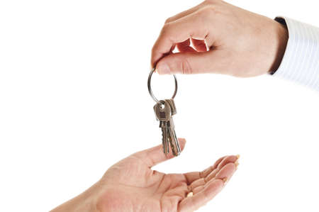 Agent man hand giving keys to womanの写真素材