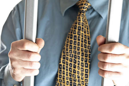 Isolated business man in jailの写真素材