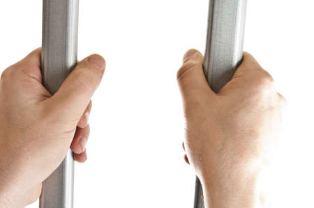 Isolated hands on jail barsの写真素材