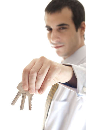 Isolated business man with key in handの写真素材