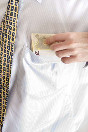 Euro banknotes in shirt pocketの写真素材