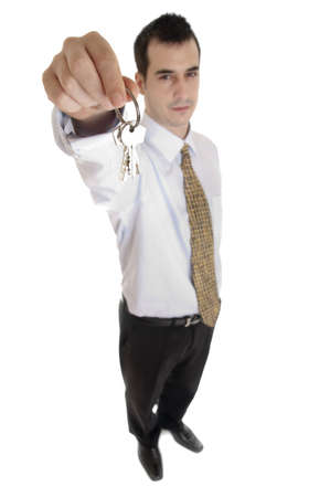 Isolated business man with key in handの写真素材