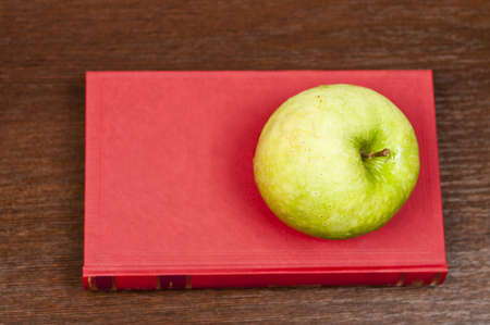 Close-up to book and appleの写真素材