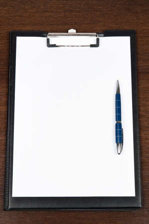 Blank notepad and blue penの写真素材
