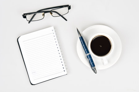 Coffee and notebook on whiteの写真素材