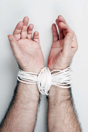 Hand tied with white ropeの写真素材