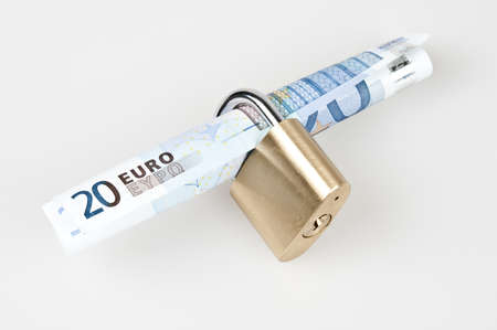 Euro banknotes in closed padlockの写真素材