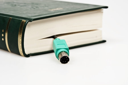 Isolated book with pc jackの写真素材