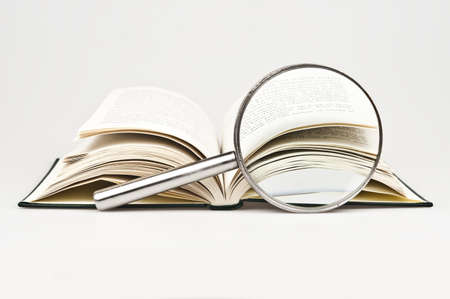 Book and magnifying glass on whiteの写真素材