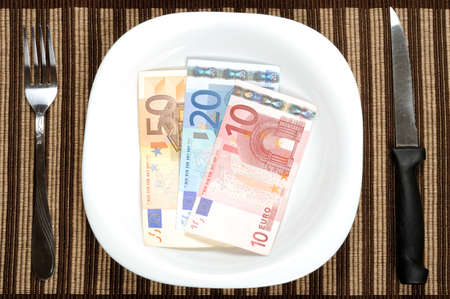 Serving euro banknotes in white plateの写真素材