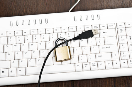 Locked cable on white keyboardの写真素材