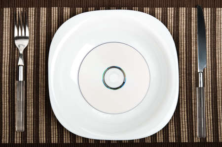 Cd on plate with fork and knifeの写真素材