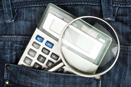 Closeup to jeans pocket with magnifying glassの写真素材