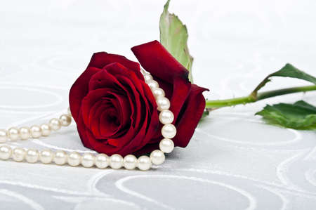 Rose and beads on silkの写真素材