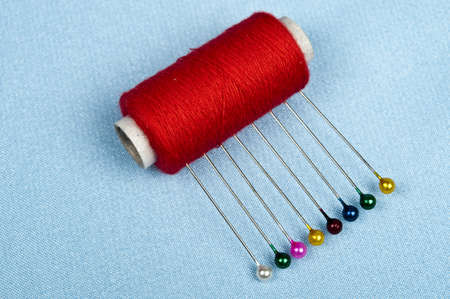 Thread on blue material backgroundの写真素材