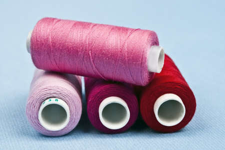Thread on blue material backgroundの写真素材