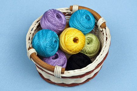 Thread in basket on blue material backgroundの写真素材