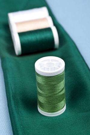 Thread on green material backgroundの写真素材