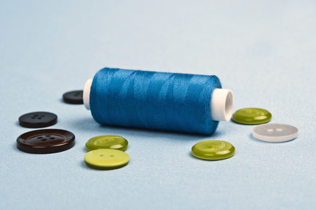 Thread and buttons on blue material backgroundの写真素材