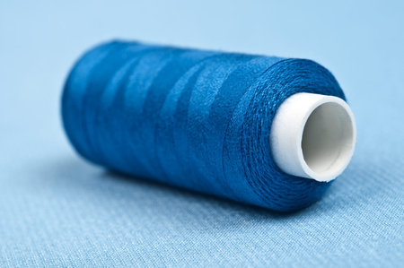 Thread on blue material backgroundの写真素材