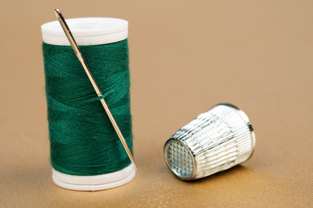 Green thread on gold materialの写真素材