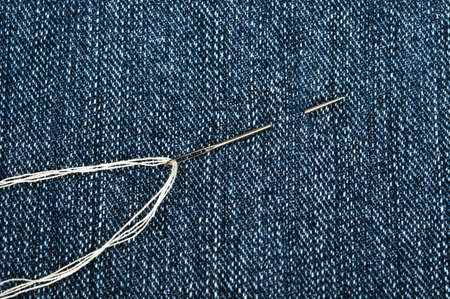 Thread on blue jeans materialの写真素材