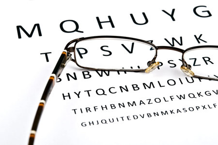 Eye glasses on examination paper