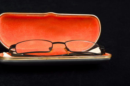 Eye glasses on black materialの写真素材