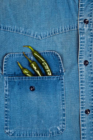 Jeans shirt pocket with green pepperの写真素材