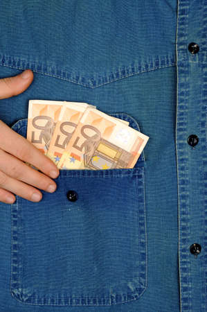 Jeans shirt pocket with moneyの写真素材