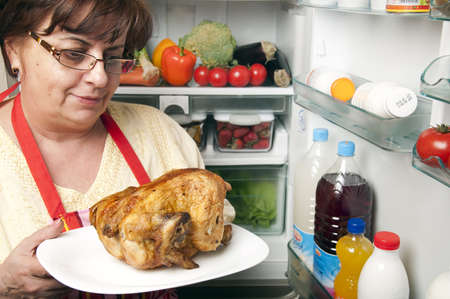 Refrigerator close up with mature womanの写真素材