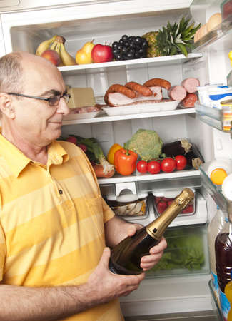 Refrigerator close up with mature manの写真素材