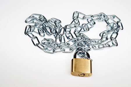 Padlock and chain on whiteの写真素材