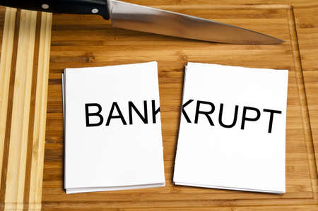 Knife cut paper with bankrupt wordの写真素材