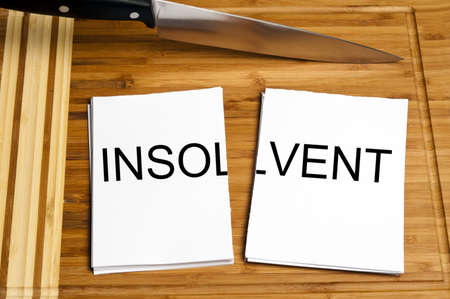 Knife cut paper with insolvent wordの写真素材