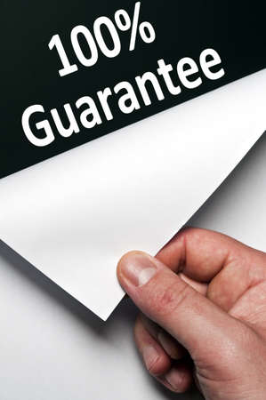 100% guarantee word discovered by male handの写真素材