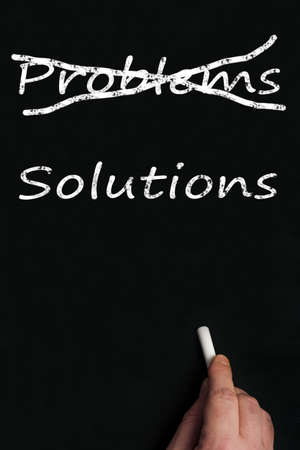 Problems and solutions write on black boardの写真素材