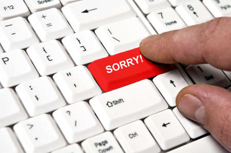 Sorry key pressed by male handの写真素材