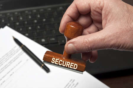 Secured stamp in male handの写真素材