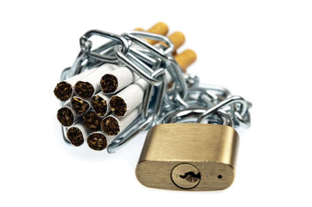 Cigarettes locked on white backgroundの写真素材