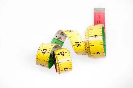 Measurement tape  and apple on whiteの写真素材