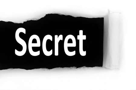 Secret word discovered under paperの写真素材