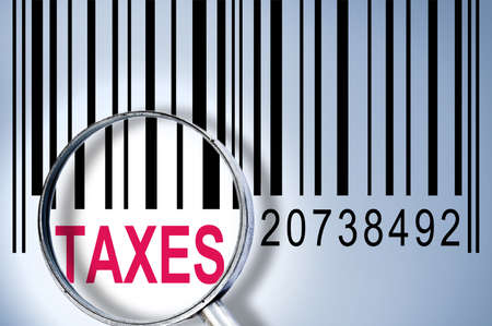Taxes under magnifyng glass on barcodeの写真素材
