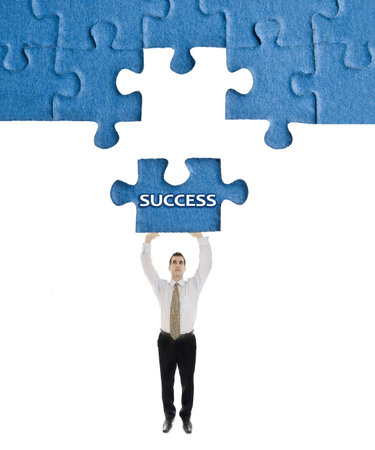 Success word on puzzle in man handsの写真素材