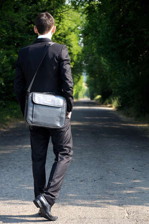 Business man walking on roadの写真素材