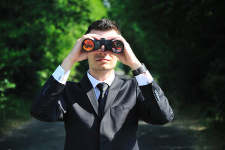 Business man looking with binocular