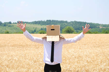 Business man hiding face with boxの写真素材