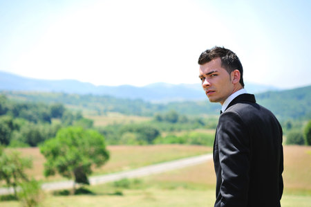 Business man standing in nature