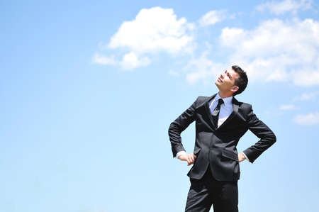 Business man looking up on skyの写真素材